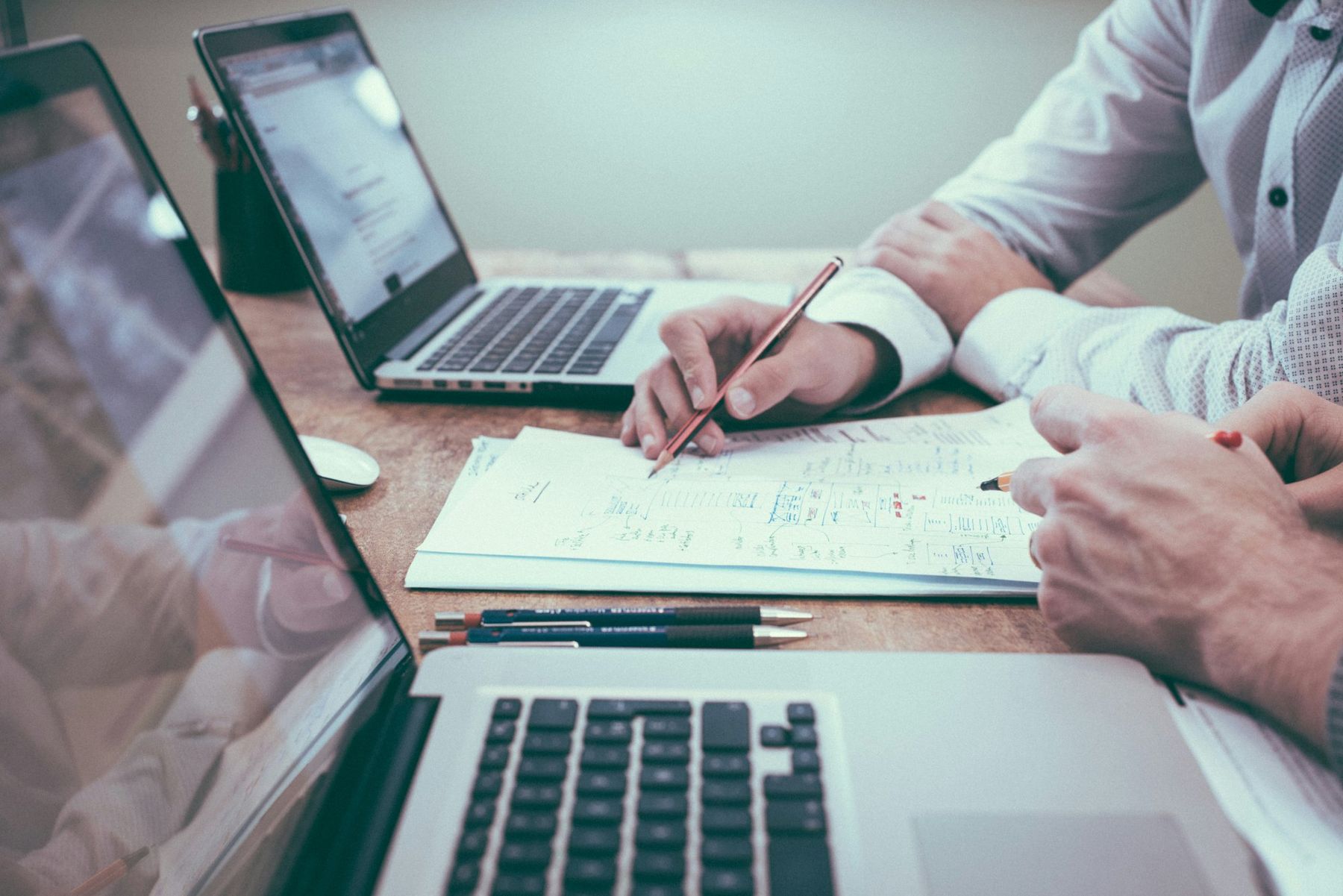 Planning notes and laptops on a meeting table